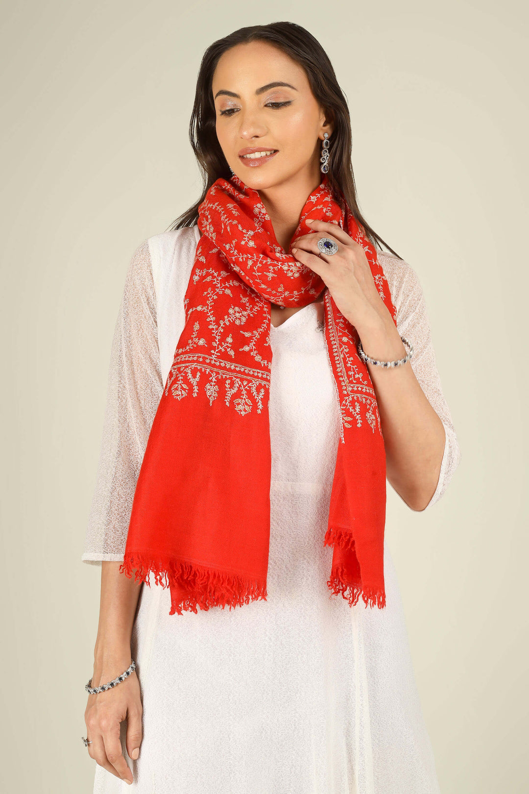 GI red Kashmiri pure pashmina embroidered stole by Kepra, draped on model in white dress, front view for Delhi winter styling
