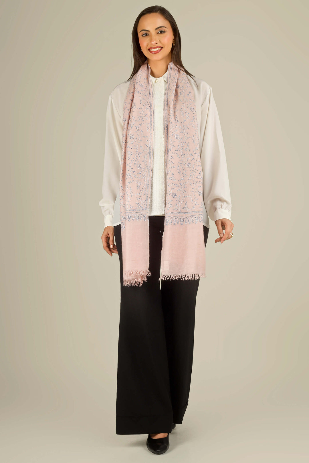 Pink Kashmiri pure pashmina embroidered stole by Kepra, draped on smiling model over white shirt and black trousers, front view