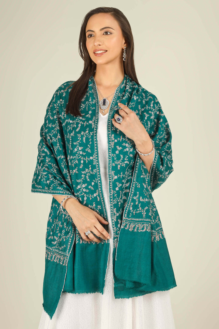 GI teal Kashmiri pure pashmina embroidered stole by Kepra, draped on smiling model in white dress, front view for Paris winter styling
    
      | pashmina shawls online | authentic Kashmiri pashmina shawl online | pure pashmina shawl online | original GI certified pashmina shawl online | luxury men's pashmina shawl online from Kashmir | where to buy online pure pashmina in India
    
    | GI Tag Certified - Government-verified authentic Kashmiri Pashmina
    | G20 Official Partner - Selected by India for G20 Summit gifting
    | Handicraft Registered - Official recognition of traditional craftsmanship
    | Certificate of Authenticity - Every purchase includes GI certification