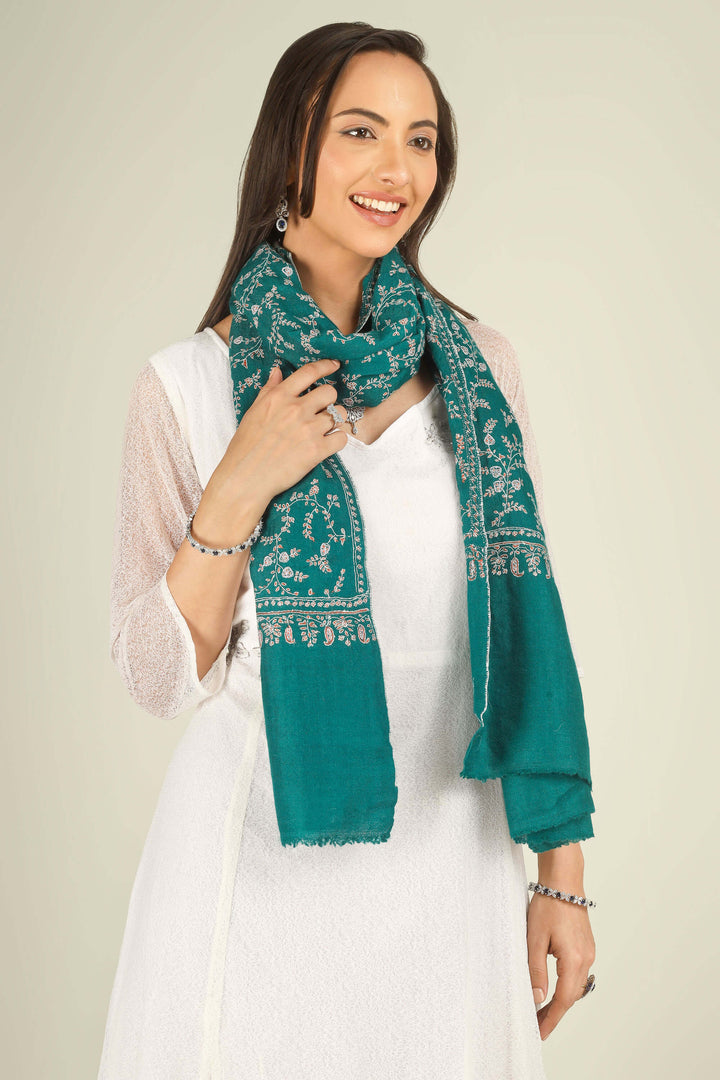 GI teal Kashmiri pure pashmina embroidered stole by Kepra, draped on smiling model in white dress, front view for Paris winter styling
    
      | pashmina shawls online | authentic Kashmiri pashmina shawl online | pure pashmina shawl online | original GI certified pashmina shawl online | luxury men's pashmina shawl online from Kashmir | where to buy online pure pashmina in India
    
    | GI Tag Certified - Government-verified authentic Kashmiri Pashmina
    | G20 Official Partner - Selected by India for G20 Summit gifting
    | Handicraft Registered - Official recognition of traditional craftsmanship
    | Certificate of Authenticity - Every purchase includes GI certification