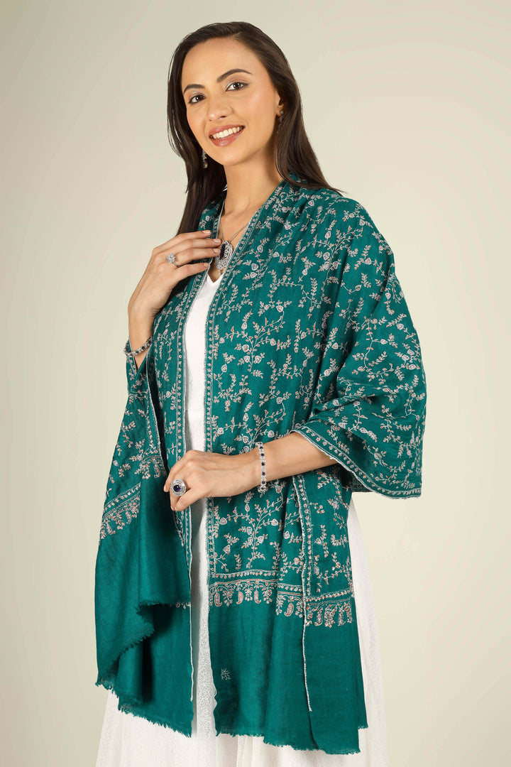 GI teal Kashmiri pure pashmina embroidered stole by Kepra, draped on smiling model in white dress, front view for Paris winter styling
    
      | pashmina shawls online | authentic Kashmiri pashmina shawl online | pure pashmina shawl online | original GI certified pashmina shawl online | luxury men's pashmina shawl online from Kashmir | where to buy online pure pashmina in India
    
    | GI Tag Certified - Government-verified authentic Kashmiri Pashmina
    | G20 Official Partner - Selected by India for G20 Summit gifting
    | Handicraft Registered - Official recognition of traditional craftsmanship
    | Certificate of Authenticity - Every purchase includes GI certification