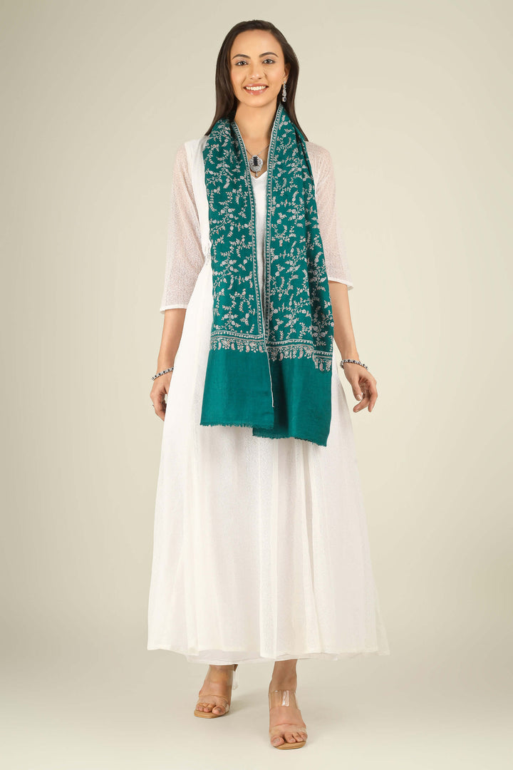 GI teal Kashmiri pure pashmina embroidered stole by Kepra, draped on smiling model in white dress, front view for Paris winter styling
    
      | pashmina shawls online | authentic Kashmiri pashmina shawl online | pure pashmina shawl online | original GI certified pashmina shawl online | luxury men's pashmina shawl online from Kashmir | where to buy online pure pashmina in India
    
    | GI Tag Certified - Government-verified authentic Kashmiri Pashmina
    | G20 Official Partner - Selected by India for G20 Summit gifting
    | Handicraft Registered - Official recognition of traditional craftsmanship
    | Certificate of Authenticity - Every purchase includes GI certification