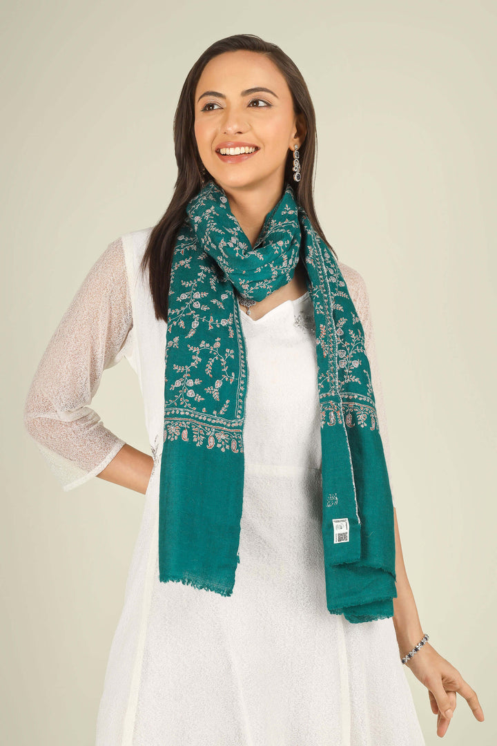 GI teal Kashmiri pure pashmina embroidered stole by Kepra, draped on smiling model in white dress, front view for Paris winter styling
    
      | pashmina shawls online | authentic Kashmiri pashmina shawl online | pure pashmina shawl online | original GI certified pashmina shawl online | luxury men's pashmina shawl online from Kashmir | where to buy online pure pashmina in India
    
    | GI Tag Certified - Government-verified authentic Kashmiri Pashmina
    | G20 Official Partner - Selected by India for G20 Summit gifting
    | Handicraft Registered - Official recognition of traditional craftsmanship
    | Certificate of Authenticity - Every purchase includes GI certification