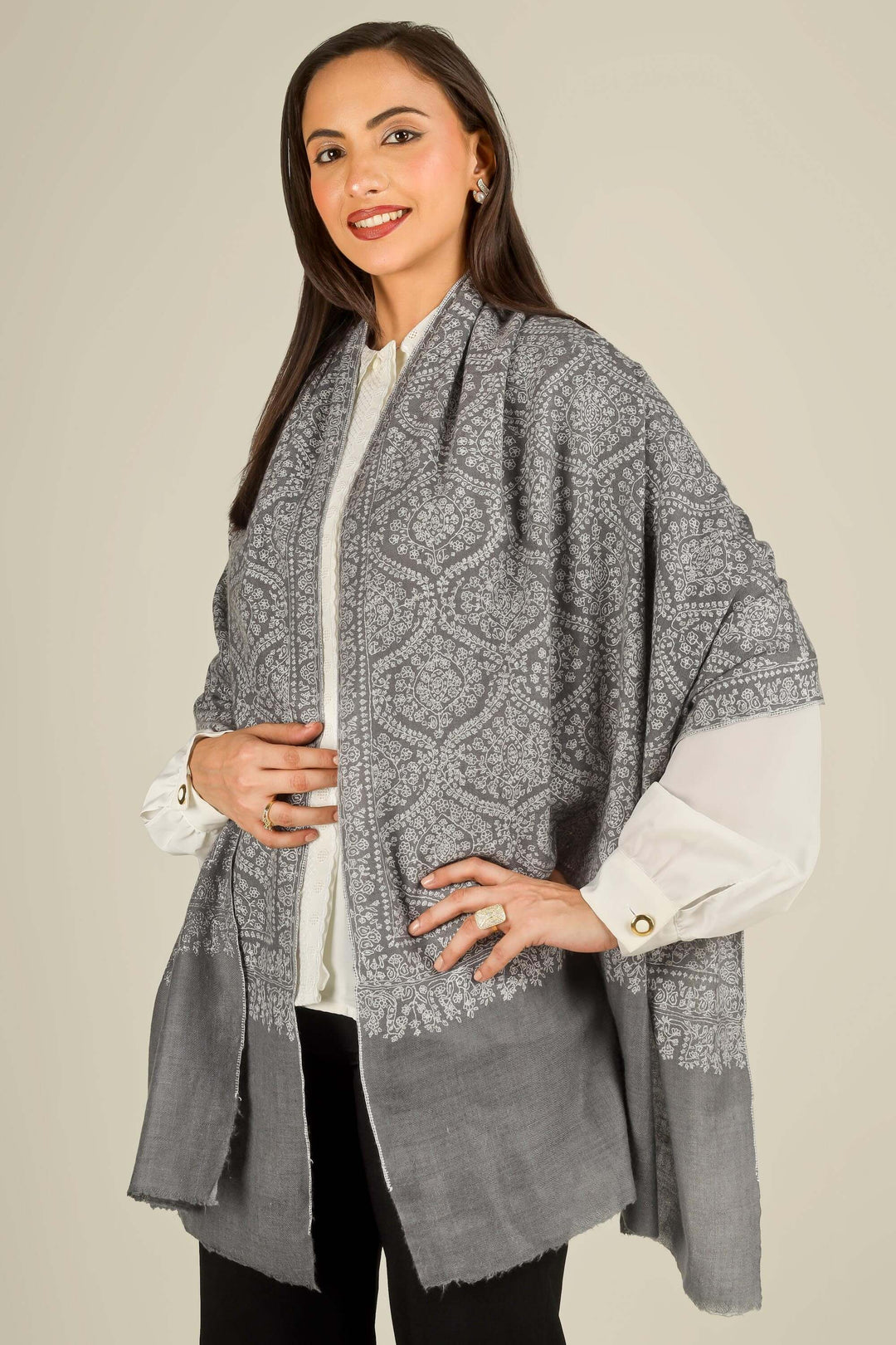 GI grey Kashmiri pure pashmina embroidered stole by Kepra, draped on smiling model over white shirt and black trousers, front view