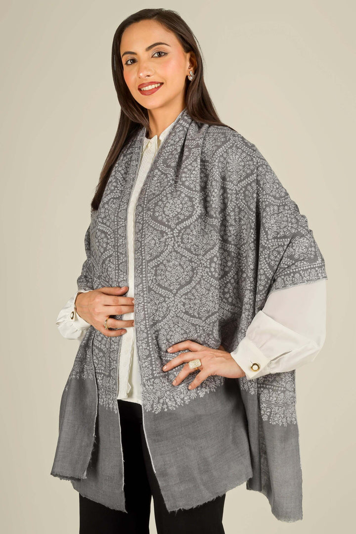 GI grey Kashmiri pure pashmina embroidered stole by Kepra, draped on smiling model over white shirt and black trousers, front view
    
      | pashmina shawls online | authentic Kashmiri pashmina shawl online | pure pashmina shawl online | original GI certified pashmina shawl online | luxury men's pashmina shawl online from Kashmir | where to buy online pure pashmina in India
    
    | GI Tag Certified - Government-verified authentic Kashmiri Pashmina
    | G20 Official Partner - Selected by India for G20 Summit gifting
    | Handicraft Registered - Official recognition of traditional craftsmanship
    | Certificate of Authenticity - Every purchase includes GI certification