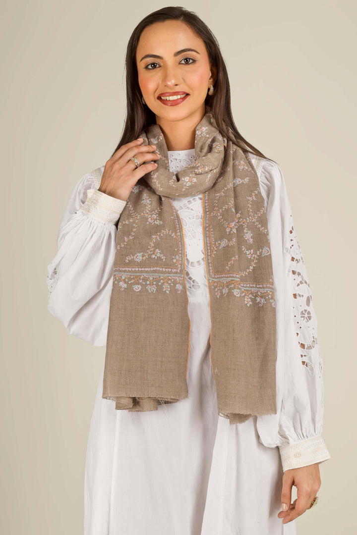 GI taupe Kashmiri pure pashmina embroidered stole by Kepra, draped over white dress on smiling model, front view
    
      | pashmina shawls online | authentic Kashmiri pashmina shawl online | pure pashmina shawl online | original GI certified pashmina shawl online | luxury men's pashmina shawl online from Kashmir | where to buy online pure pashmina in India
    
    | GI Tag Certified - Government-verified authentic Kashmiri Pashmina
    | G20 Official Partner - Selected by India for G20 Summit gifting
    | Handicraft Registered - Official recognition of traditional craftsmanship
    | Certificate of Authenticity - Every purchase includes GI certification
