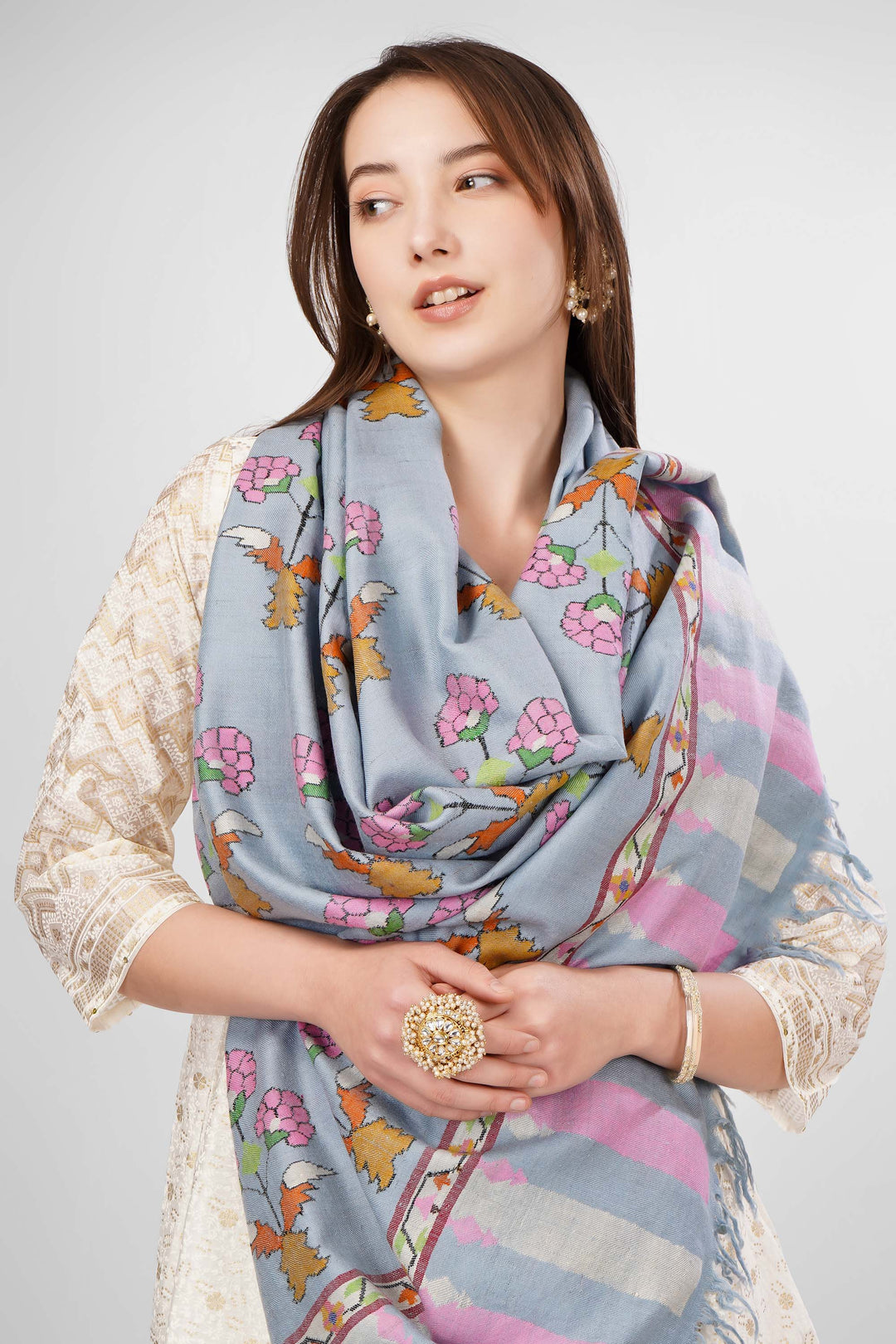 Pastel Blue GI-Tagged Pashmina Kani Shawl Online , The GI tag is your guarantee that this shawl is made by Kashmiri artisans using genuine pashmina wool spun and woven by hand, and not a machine-made imitation. It protects the traditional craft