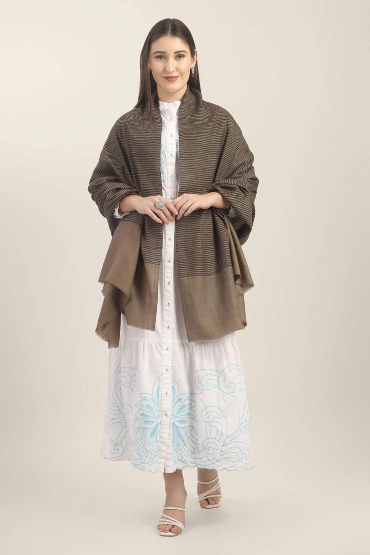 Model holding a taupe Pure Kashmiri Pashmina shawl with fine black woven stripes and a wide plain border over a white embroidered dress.
    
      | pashmina shawls online | authentic Kashmiri pashmina shawl online | pure pashmina shawl online | original GI certified pashmina shawl online | luxury men's pashmina shawl online from Kashmir | where to buy online pure pashmina in India
    
    | GI Tag Certified - Government-verified authentic Kashmiri Pashmina
    | G20 Official Partner - Selected by India for G20 Summit gifting
    | Handicraft Registered - Official recognition of traditional craftsmanship
    | Certificate of Authenticity - Every purchase includes GI certification