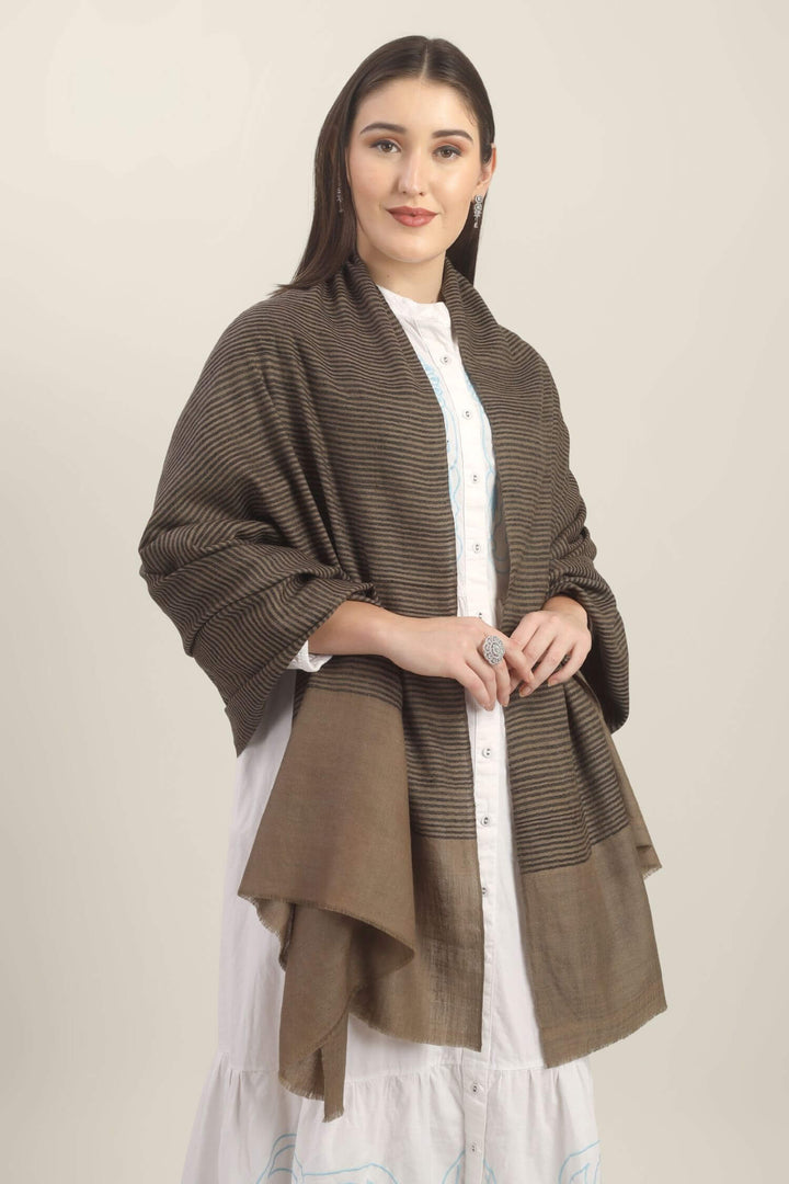 Model holding a taupe Pure Kashmiri Pashmina shawl with fine black woven stripes and a wide plain border over a white embroidered dress.
    
      | pashmina shawls online | authentic Kashmiri pashmina shawl online | pure pashmina shawl online | original GI certified pashmina shawl online | luxury men's pashmina shawl online from Kashmir | where to buy online pure pashmina in India
    
    | GI Tag Certified - Government-verified authentic Kashmiri Pashmina
    | G20 Official Partner - Selected by India for G20 Summit gifting
    | Handicraft Registered - Official recognition of traditional craftsmanship
    | Certificate of Authenticity - Every purchase includes GI certification
