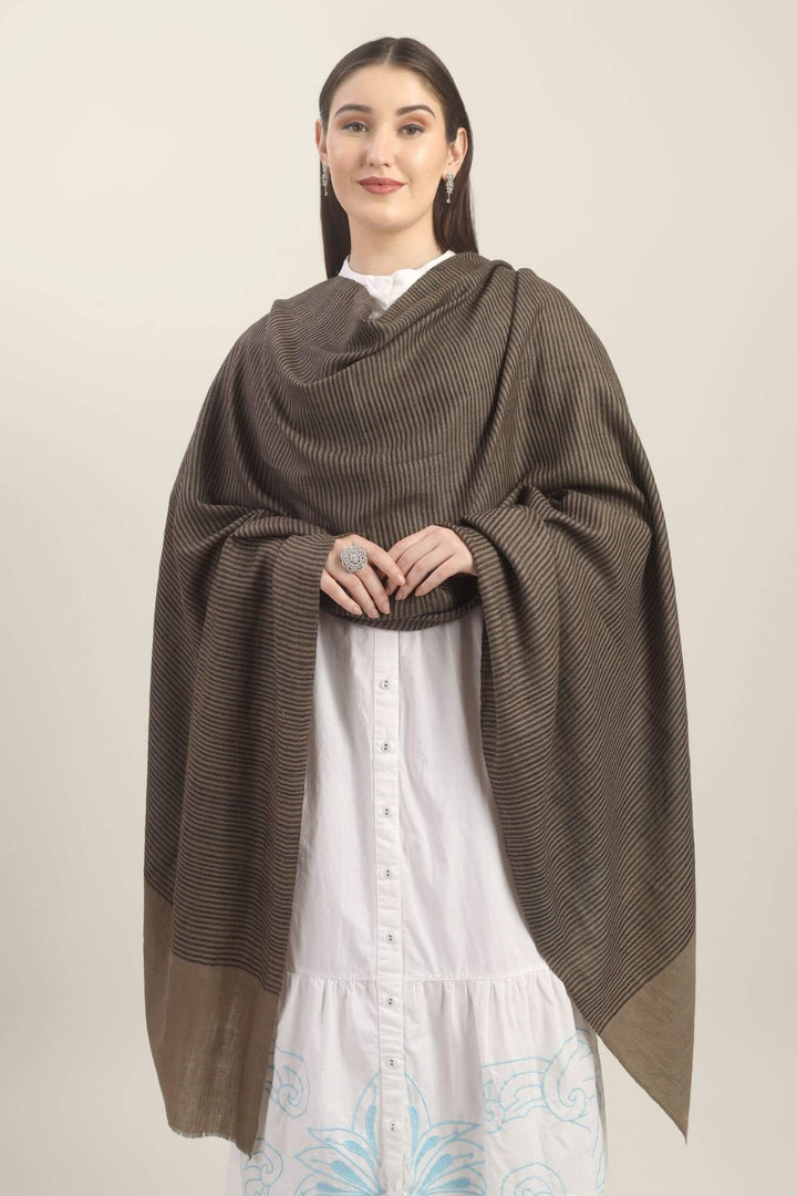 Model holding a taupe Pure Kashmiri Pashmina shawl with fine black woven stripes and a wide plain border over a white embroidered dress.
    
      | pashmina shawls online | authentic Kashmiri pashmina shawl online | pure pashmina shawl online | original GI certified pashmina shawl online | luxury men's pashmina shawl online from Kashmir | where to buy online pure pashmina in India
    
    | GI Tag Certified - Government-verified authentic Kashmiri Pashmina
    | G20 Official Partner - Selected by India for G20 Summit gifting
    | Handicraft Registered - Official recognition of traditional craftsmanship
    | Certificate of Authenticity - Every purchase includes GI certification