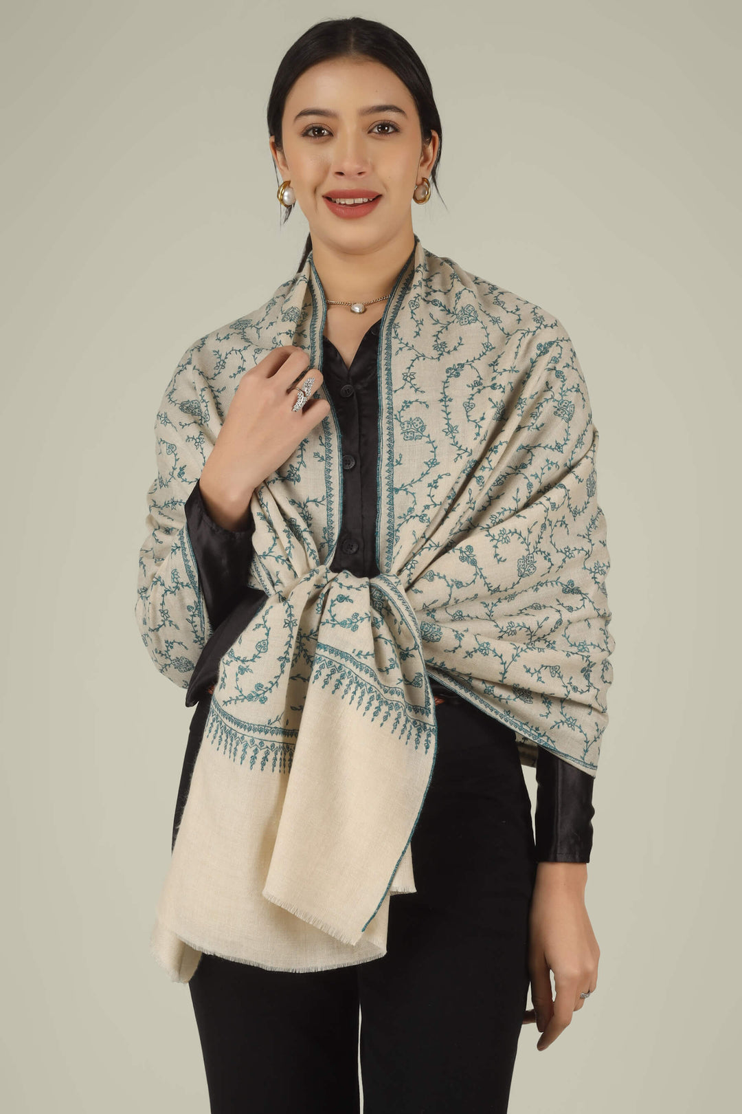 Hand-embroidered ivory off-white pure Pashmina stole featuring an all-over teal Sozni Jaldaar floral vine pattern from Kepra.