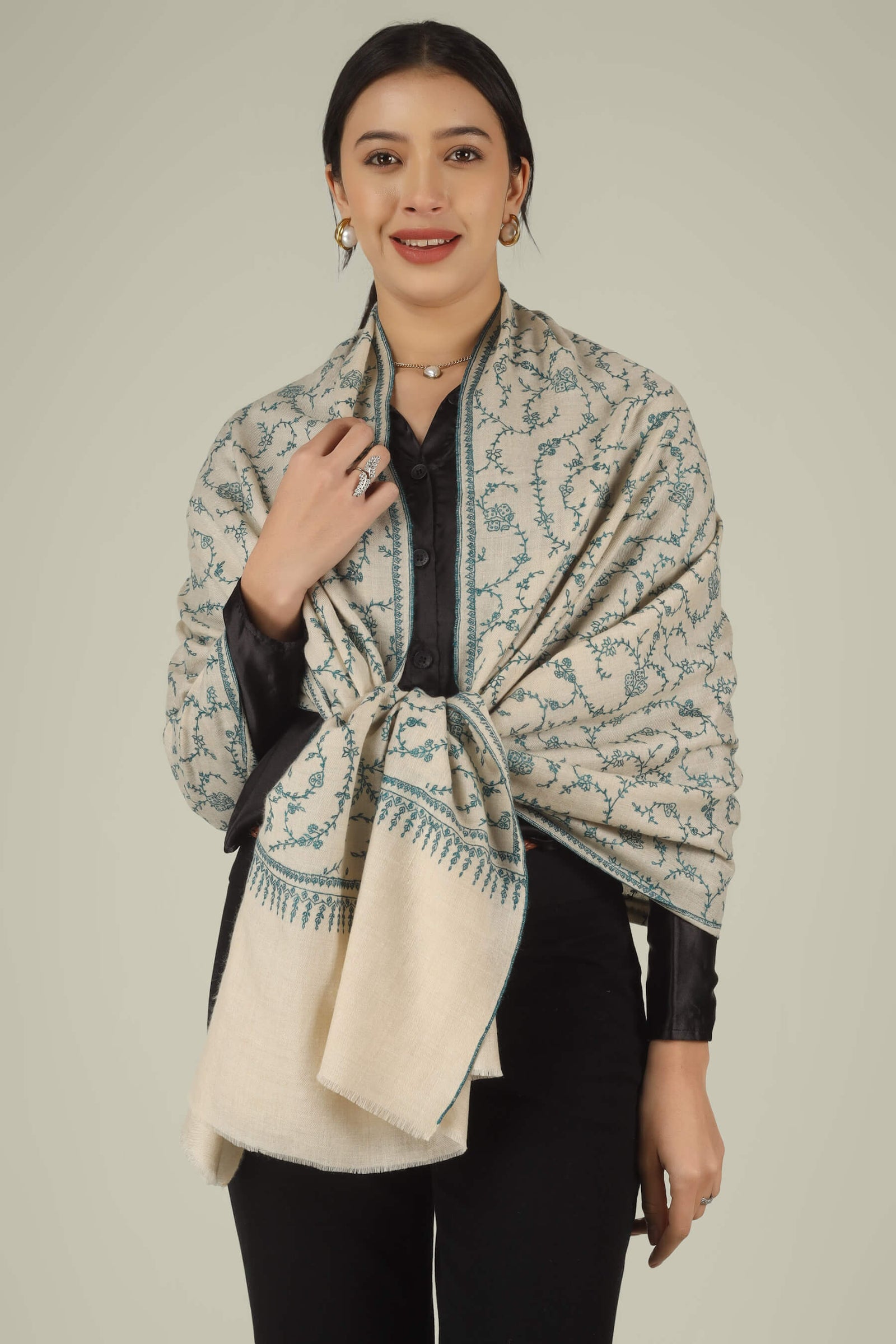 Hand-embroidered ivory off-white pure Pashmina stole featuring an all-over teal Sozni Jaldaar floral vine pattern from Kepra.