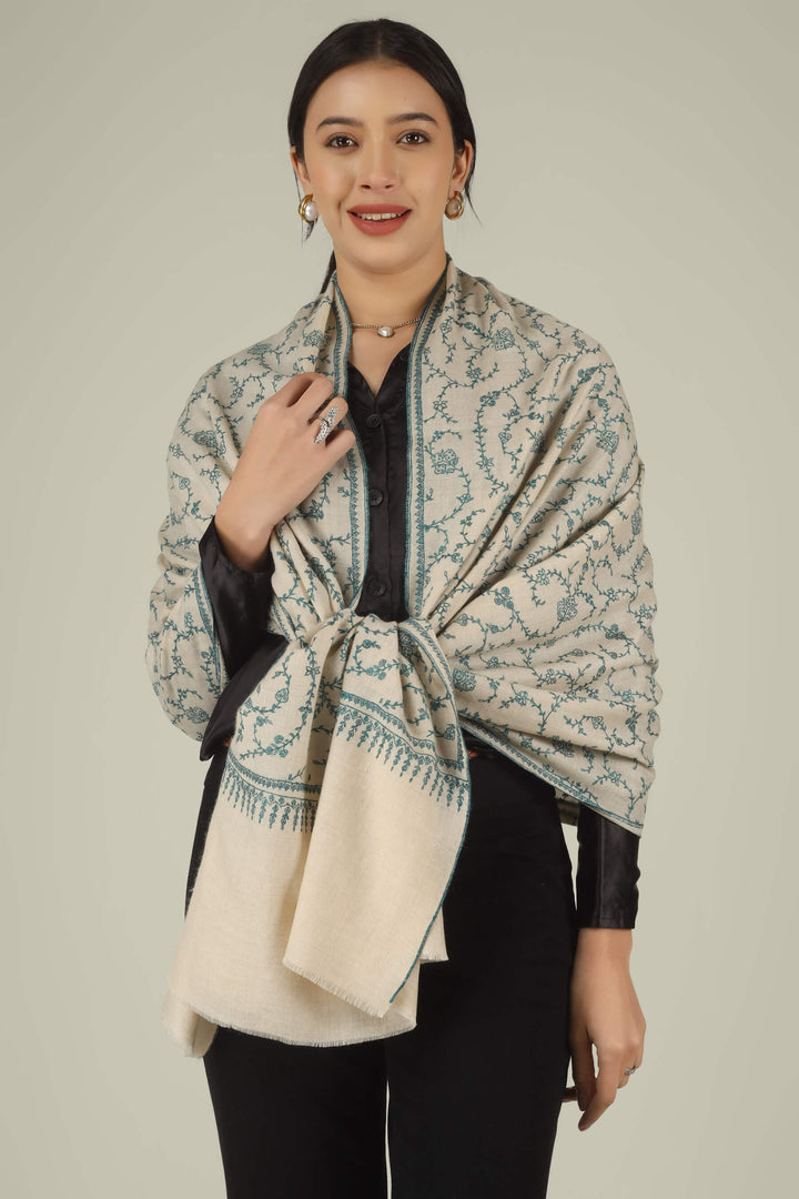 Hand-embroidered ivory off-white pure Pashmina stole featuring an all-over teal Sozni Jaldaar floral vine pattern from Kepra.
    
      | pashmina shawls online | authentic Kashmiri pashmina shawl online | pure pashmina shawl online | original GI certified pashmina shawl online | luxury men's pashmina shawl online from Kashmir | where to buy online pure pashmina in India
    
    | GI Tag Certified - Government-verified authentic Kashmiri Pashmina
    | G20 Official Partner - Selected by India for G20 Summit gifting
    | Handicraft Registered - Official recognition of traditional craftsmanship
    | Certificate of Authenticity - Every purchase includes GI certification