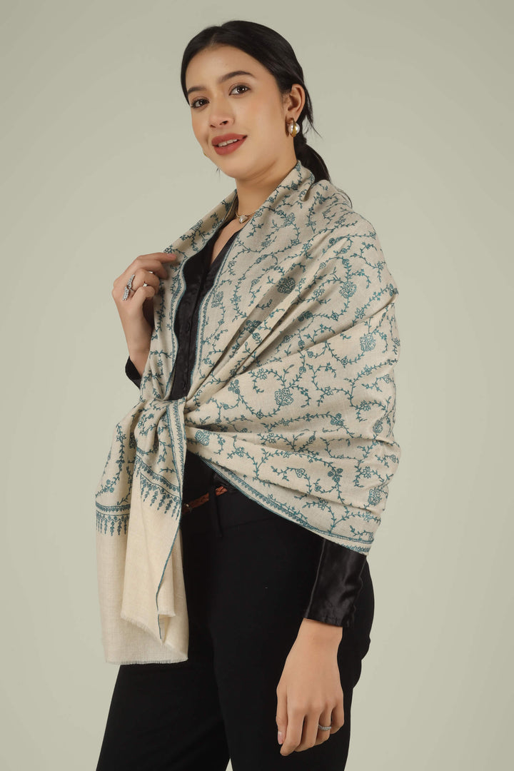 Hand-embroidered ivory off-white pure Pashmina stole featuring an all-over teal Sozni Jaldaar floral vine pattern from Kepra.
    
      | pashmina shawls online | authentic Kashmiri pashmina shawl online | pure pashmina shawl online | original GI certified pashmina shawl online | luxury men's pashmina shawl online from Kashmir | where to buy online pure pashmina in India
    
    | GI Tag Certified - Government-verified authentic Kashmiri Pashmina
    | G20 Official Partner - Selected by India for G20 Summit gifting
    | Handicraft Registered - Official recognition of traditional craftsmanship
    | Certificate of Authenticity - Every purchase includes GI certification
