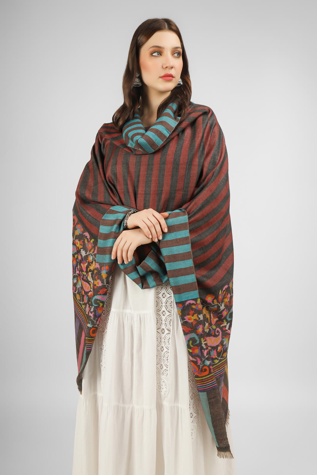 Indulge in the luxury of this handmade in Kashmir, stripe reversible paladaar Kani Pashmina Shawl, featuring beautiful designs in floral and paisley patterns crafted by expert and skillful artisans. Stay warm and cozy while looking stylish in this luxurious and warm shawl.