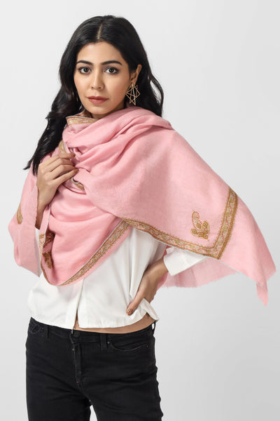  Would you like to lend yourself some luxury from the traditions of Kashmir in celebration with the age-old craft of Sozni Kaari? Here is a delicately and brilliantly mastered Pink colored Pashmina Stole embroidered with the classical needlework of Valley along its borders.