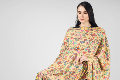 The blooming almond blossoms direct from the alcoves and gardens of Kashmir are elegantly hand-woven onto a luxurious, soft and warm yellow Pashmina Shawl,