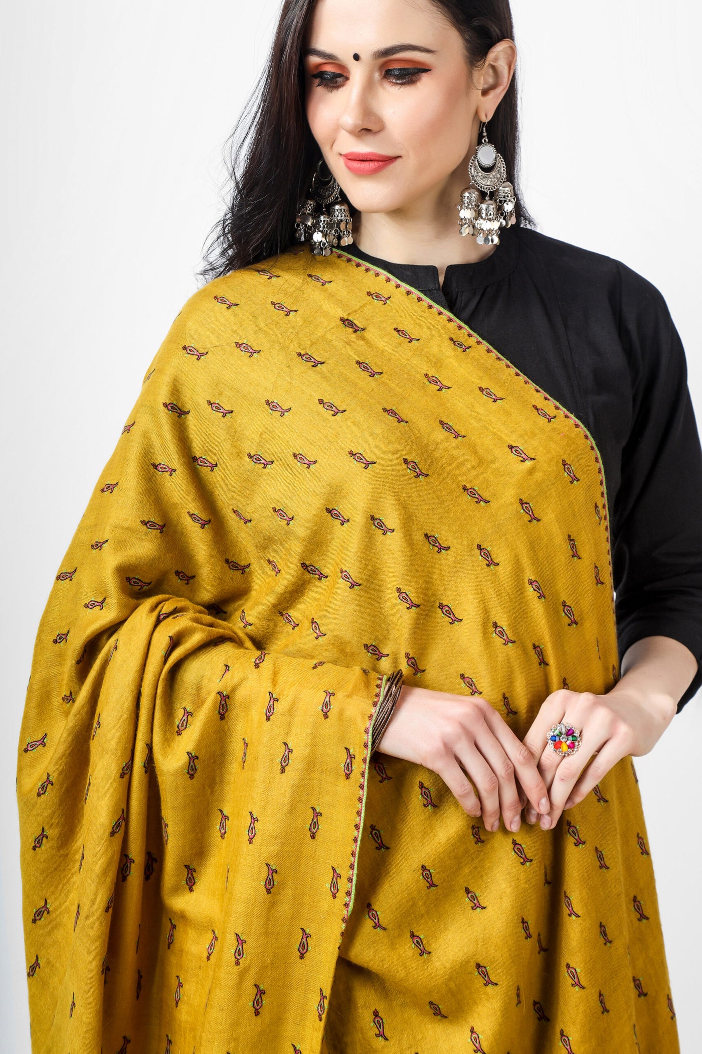 The Mustard Pashmina Shawl mentioned above is an exquisite shawl that showcases the intricate and fine Sozni Embroidery. This type of embroidery is done all over the shawl in a traditional bootidaar pattern. With its unique design and high-quality craftsmanship, this shawl is sure to make you stand out in any crowd.