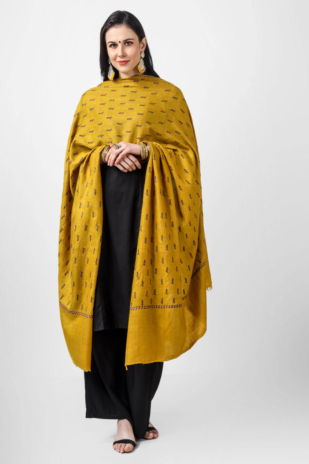 The Mustard Pashmina Shawl mentioned above is an exquisite shawl that showcases the intricate and fine Sozni Embroidery. This type of embroidery is done all over the shawl in a traditional bootidaar pattern. With its unique design and high-quality craftsmanship, this shawl is sure to make you stand out in any crowd.