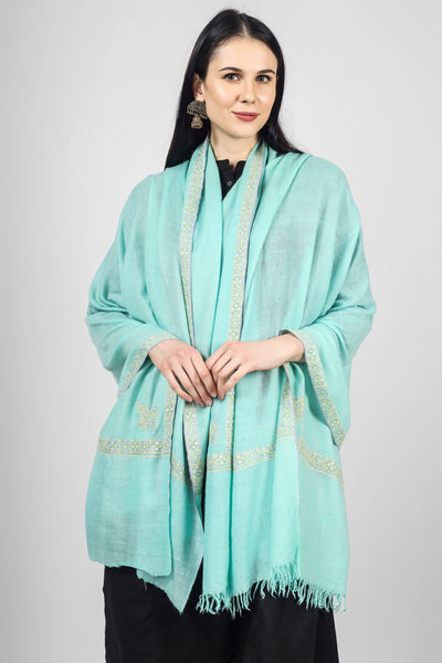  Stay warm and stylish this winter with a luxurious Pashmina shawl, featuring delicate Sozni embroidery and premium quality materials. Exclusively crafted and passionately woven, this ravishing turquoise Pashmina Shawl has been ornated with a beautiful Sozni border, traditionally called the Hashidaar pattern. 