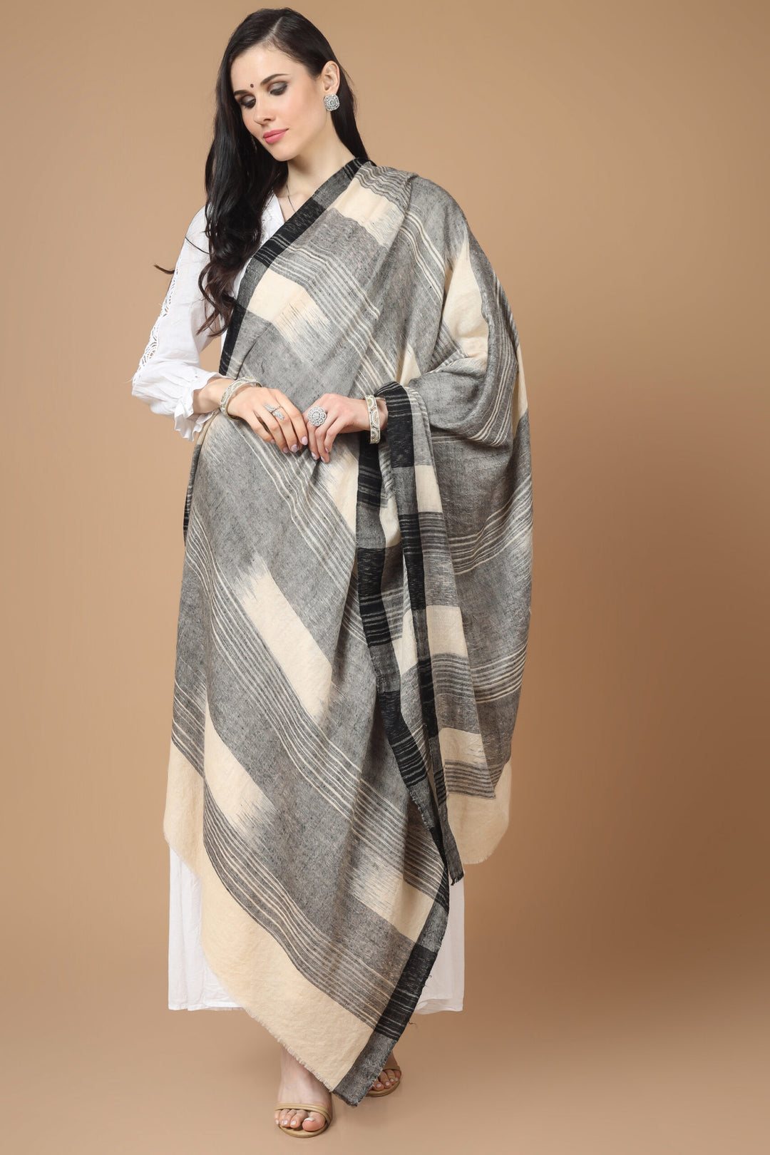 This luxurious, authentic and handmade Pashmina Stole, designed in a Kuwait Ikkat pattern, is crafted by the most talented and skilled Kashmiri Artisans. 