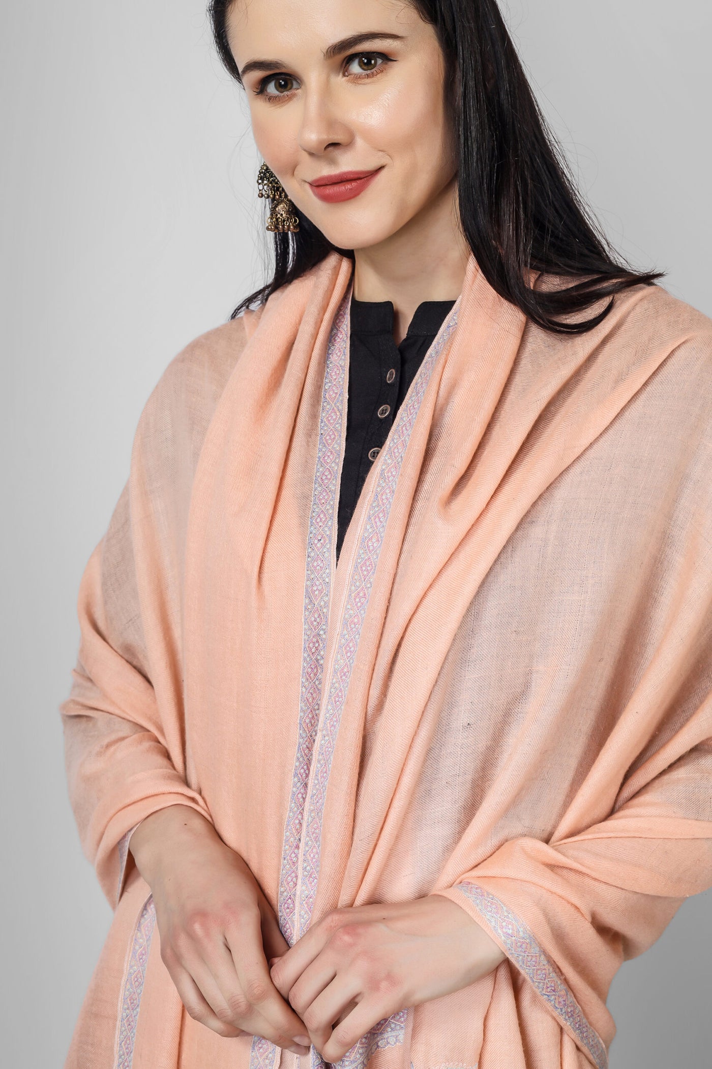 This peach pashmina mehnoor hashidaar is elegant and very different design In addition to their beautiful designs, our pashmina shawls are also versatile fashion accessories. They can be worn in a variety of ways, from draped over the shoulders to wrapped around the neck like a scarf. they are so warm and comfortable