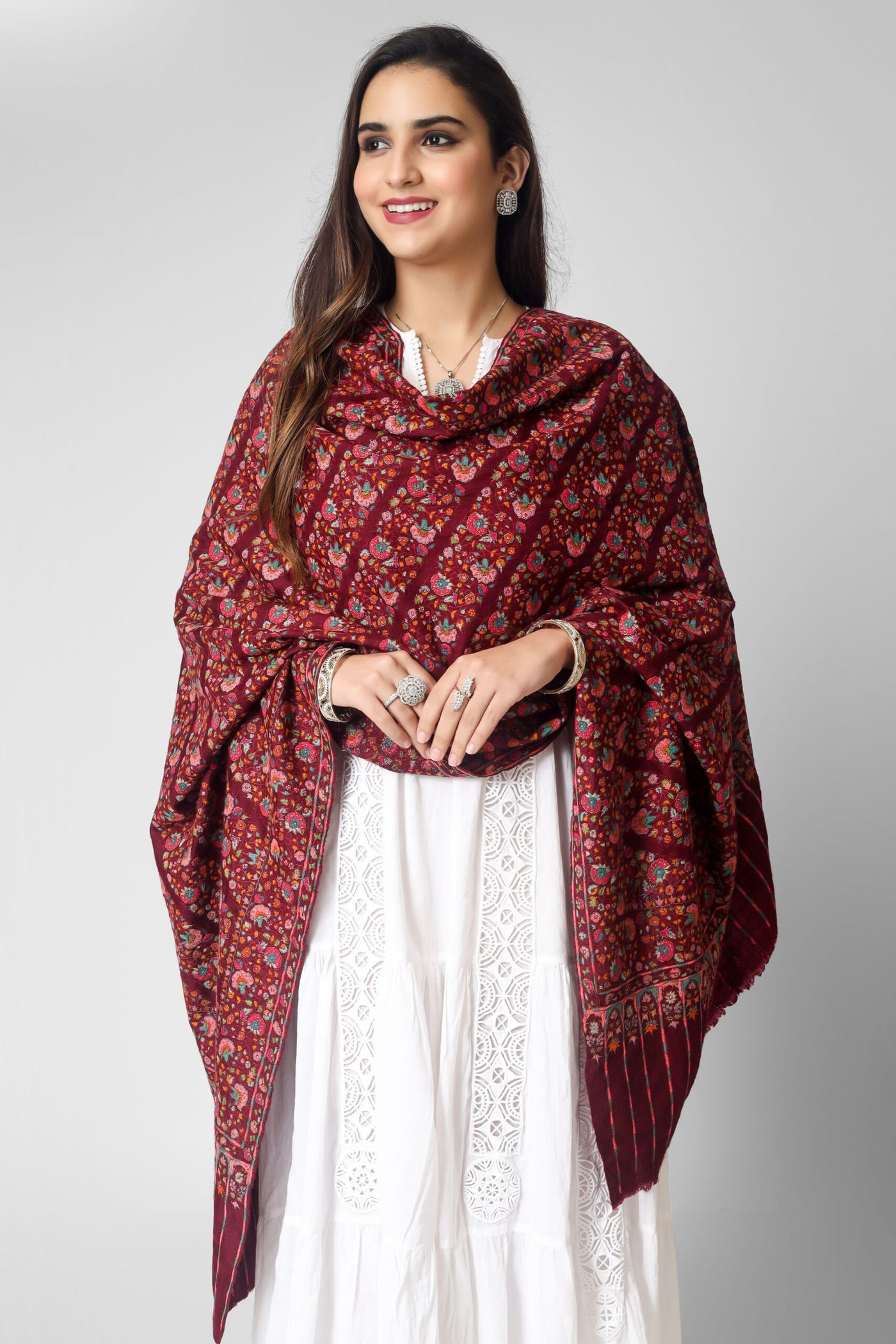  A passionate and ravishing wine color Pashmina Shawl in combination with the legendary paper mache Sozni Embroidery in intricate Jaldaar khatras. 