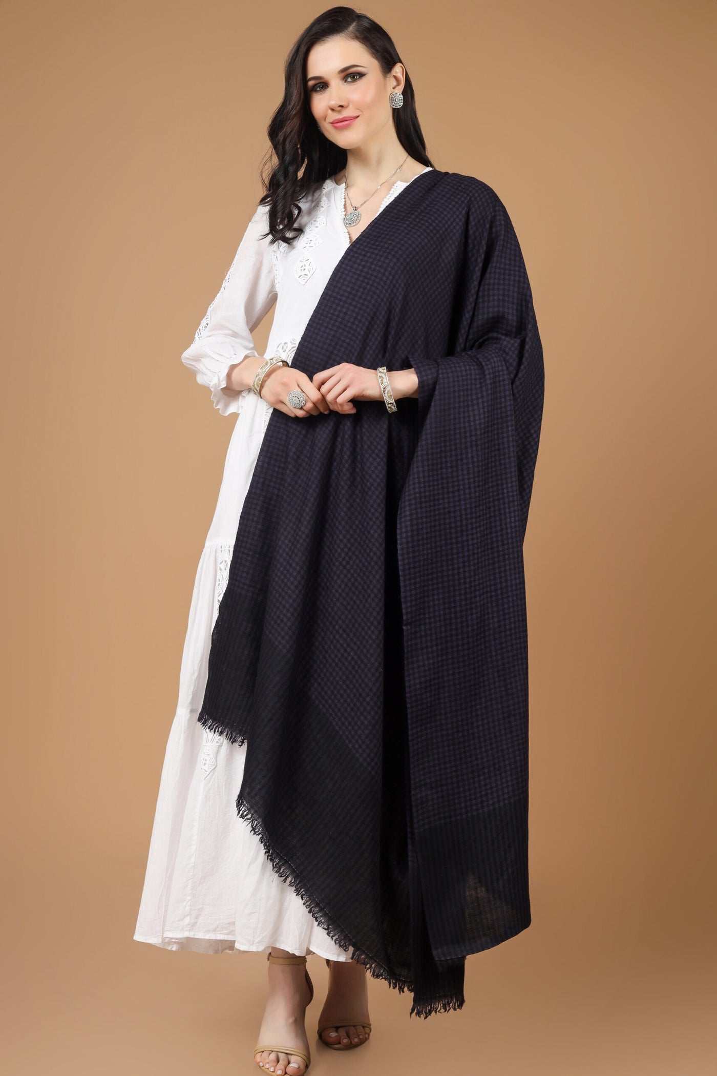  With this amazing Kashmiri pashmina stole, you can wrap yourself in luxury. It is elegantly crafted in a multi-check pattern with a blend of purple and black, and it features lovely embroidery and gorgeous designs. The handmade nature of this designer pashmina stole guarantees its warmth and enduring luxury .