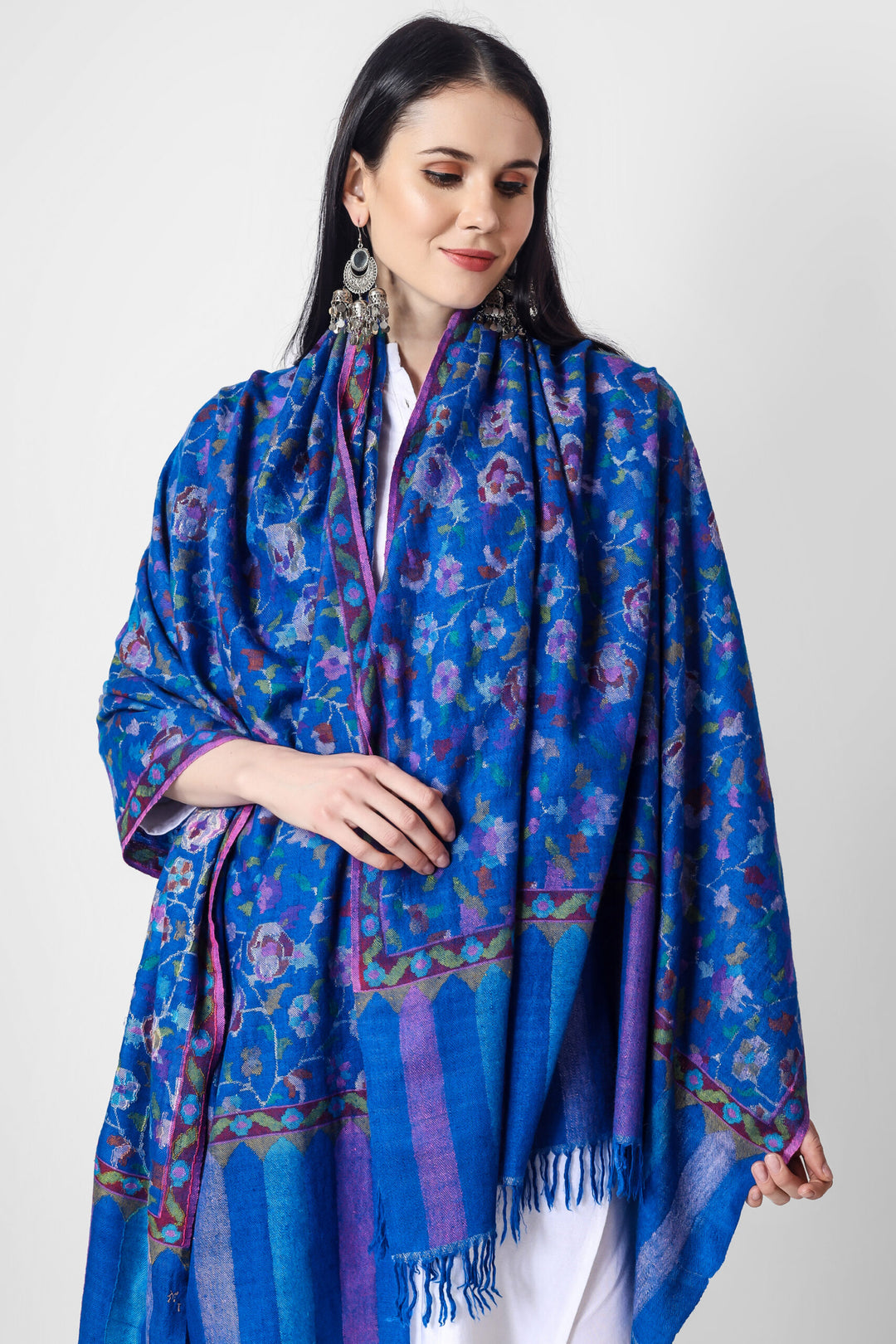 This elegant Blue Pashmina kani shawl features dancing florals and motifs in all the colors of nature skilled in the same splendid Kani weave. 