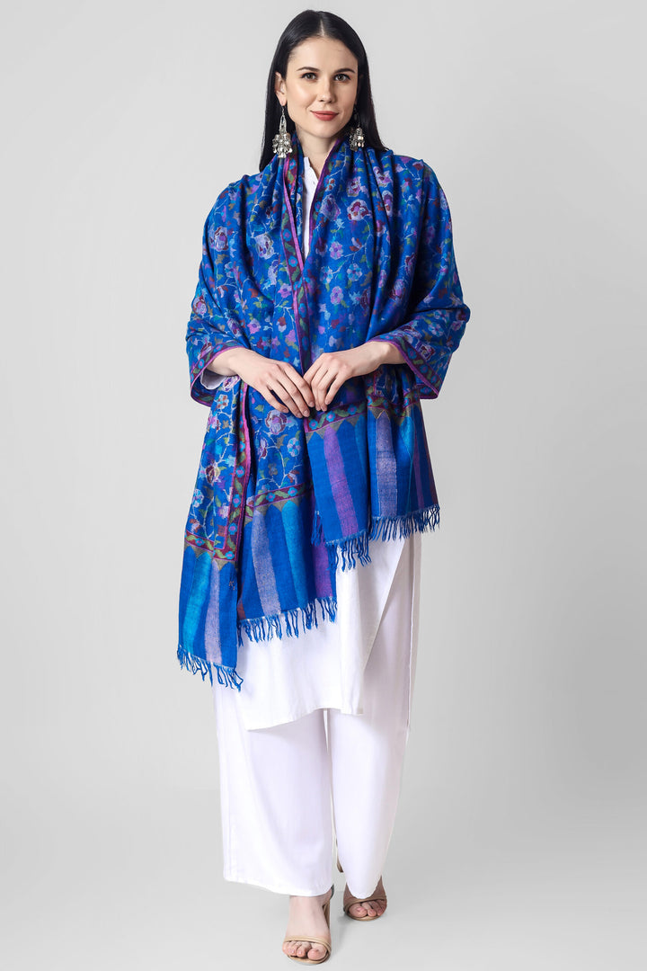 This elegant Blue Pashmina kani shawl features dancing florals and motifs in all the colors of nature skilled in the same splendid Kani weave. 