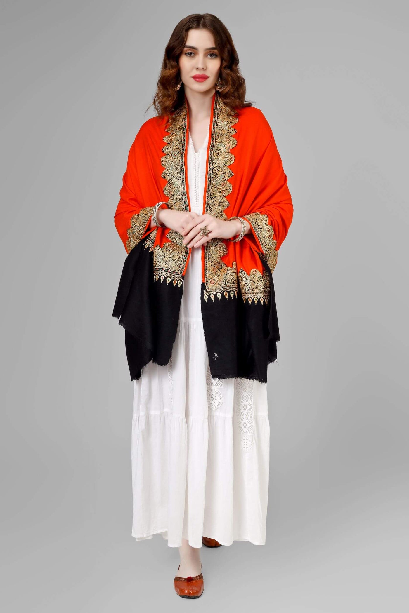  This exclusively crafted and passionately woven orange/black Pashmina Shawl has been adorned with shimmery golden Tilla equally on its four borders,  lending you the luxury of age-old Tilla and the royalty of Pashmina and you will feel both stylish and traditional, adding a touch of sophistication to your attire. 